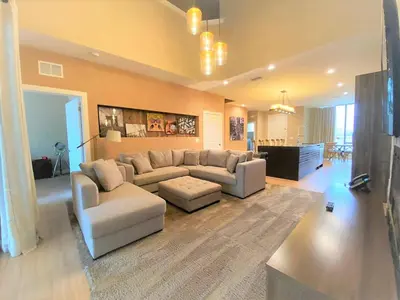 a large living room with a couch and a table at 7562 Magic Village nice 8guests 4suites 8 min Disney in Orlando
