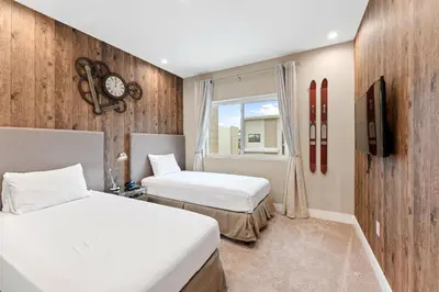 a hotel room with two beds and a window at 7562 Magic Village nice 8guests 4suites 8 min Disney in Orlando
