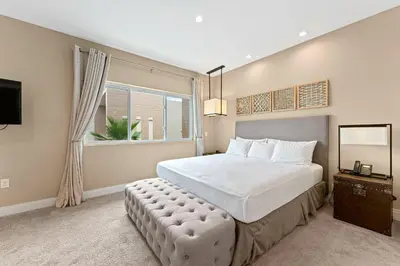 a bedroom with a large bed and a window at 7562 Magic Village nice 8guests 4suites 8 min Disney in Orlando
