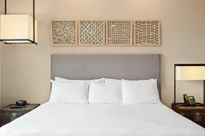 a bedroom with a white bed with two night stands at 7562 Magic Village nice 8guests 4suites 8 min Disney in Orlando