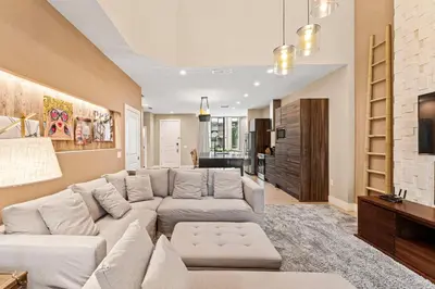 a living room with a couch and a tv at 7562 Magic Village nice 8guests 4suites 8 min Disney in Orlando