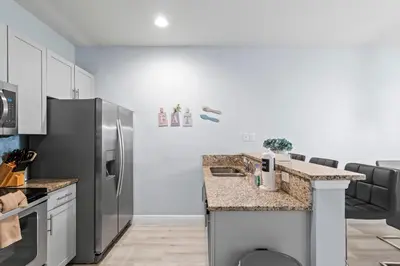 a kitchen with a stainless steel refrigerator and counters at 3212 WL 8 guests corner 192 near from Disney in Kissimmee