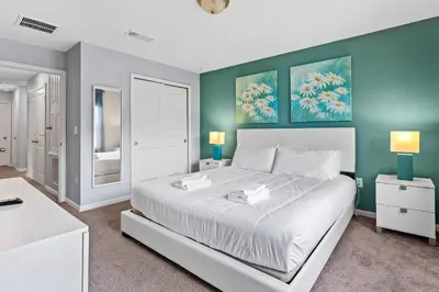 a bedroom with a white bed and green walls at 5129 Tasty renovated 8 guests BBQ near Disney in Kissimmee