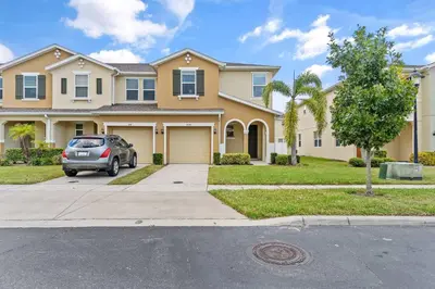 a car parked in front of a house at 5129 Tasty renovated 8 guests BBQ near Disney in Kissimmee