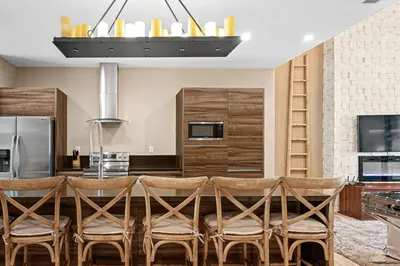 a kitchen with a table with chairs and a refrigerator at 7462 Magic Village 8guests 4suites near Disney and 192 in Orlando