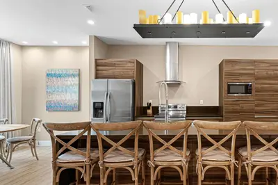 a kitchen with a table and chairs and a refrigerator at 7462 Magic Village 8guests 4suites near Disney and 192 in Orlando