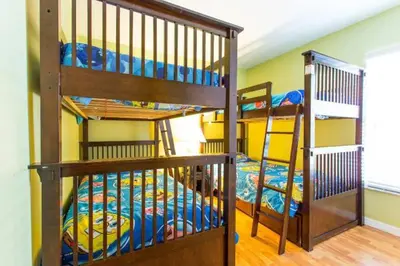 a room with two bunk beds and a ladder at Eva Kingdom back to forest home close to disney in Kissimmee