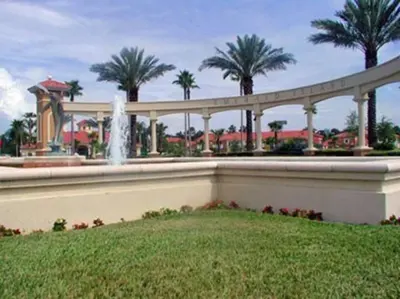 a fountain in front of a park with palm trees at Eva Kingdom back to forest home close to disney in Kissimmee