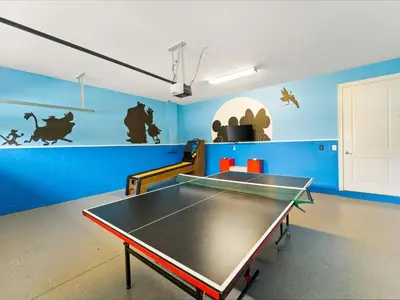 a ping pong table in a room with blue walls at Cheerful Home Near Disney With Themed Rooms, Pool Table & Waterpark And Resort Access At Encore Resorts Reunion - 200Mn in Kissimmee