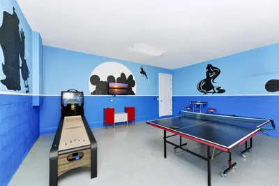 a room with a ping pong table and a ping pong ball at Cheerful Home Near Disney With Themed Rooms, Pool Table & Waterpark And Resort Access At Encore Resorts Reunion - 200Mn in Kissimmee