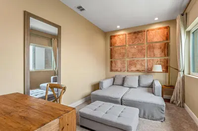 a living room with a couch and a table at 7478 Magic Village 8guests 4suites 8min Disney in Orlando