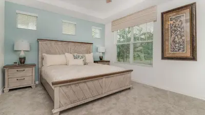 a bedroom with a large bed and a window at 8972 Amelia Downs in Orlando