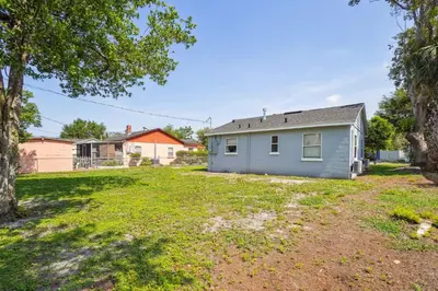 an empty yard in front of a house at 6 Mi to Downtown Orlando Quiet Home with Sunroom in Orlando