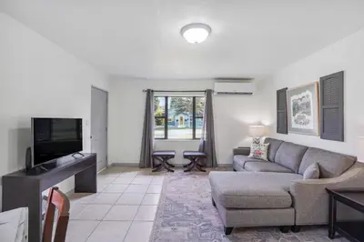 a living room with a couch and a tv at 6 Mi to Downtown Orlando Quiet Home with Sunroom in Orlando