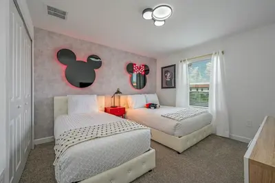 a bedroom with two beds and an apple on the wall at Families Deluxe Dream Vacation 10 min from Disney in Kissimmee