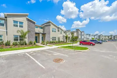 a parking lot in front of a apartment complex at Families Deluxe Dream Vacation 10 min from Disney in Kissimmee