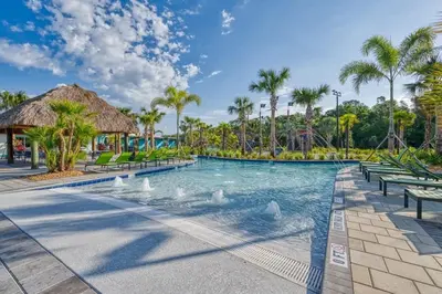 a pool at the resort with swans in the water at Families Deluxe Dream Vacation 10 min from Disney in Kissimmee