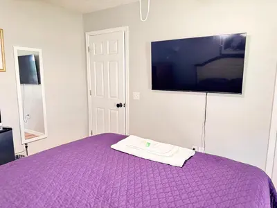 a purple bed with a towel on top of it at Near Disney cozy quiet place 2 privet rooms queen bed up to 4 people in Orlando