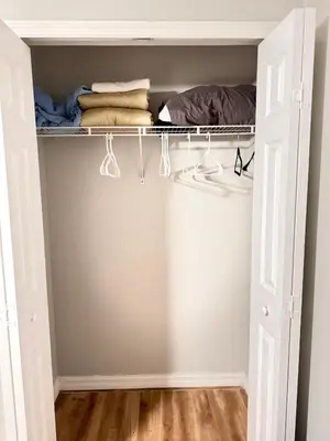 a closet with white doors and a shelf with clothes at Near Disney cozy quiet place 2 privet rooms queen bed up to 4 people in Orlando