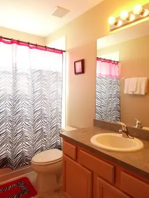 a bathroom with a toilet and a sink and a shower at Edwin Island - Luxury home, Excellent location, Gated-Community in Kissimmee