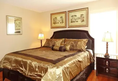 a bedroom with a large bed with gold sheets at Edwin Island - Luxury home, Excellent location, Gated-Community in Kissimmee