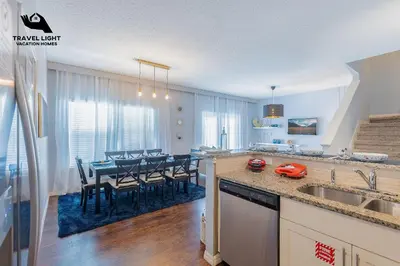 a kitchen and dining room with a dining table at Themed Home Near Disney World in Kissimmee