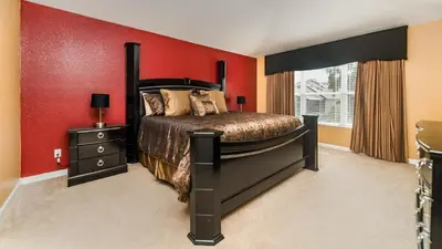 a bedroom with a bed and a red wall at 2501 Archfeld in Kissimmee