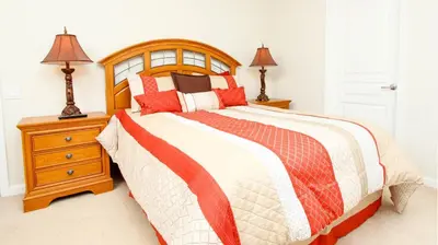 a bedroom with a large bed and a night stand at 2505 Archfeld in Kissimmee