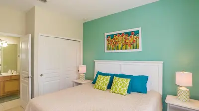 a bedroom with a bed with blue walls at 2568 Archfeld in Kissimmee