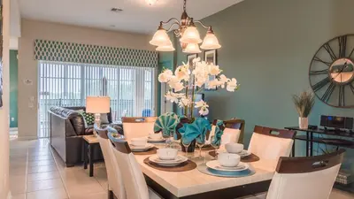 a dining room and living room with a table and chairs at 2568 Archfeld in Kissimmee
