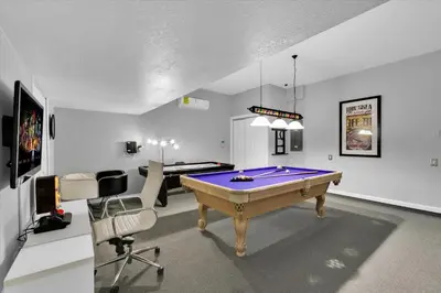 a room with a pool table and two chairs at 2574 Archfeld in Kissimmee