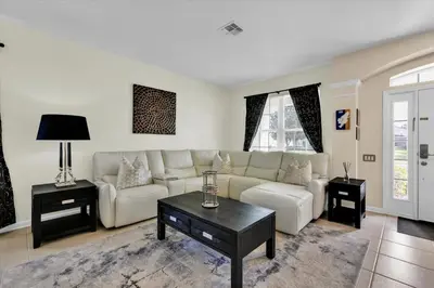 a living room with a couch and a table at 2574 Archfeld in Kissimmee