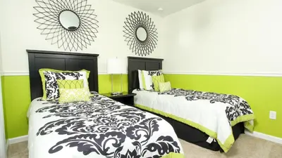 two beds in a room with green and white at 2582 Archfeld in Kissimmee