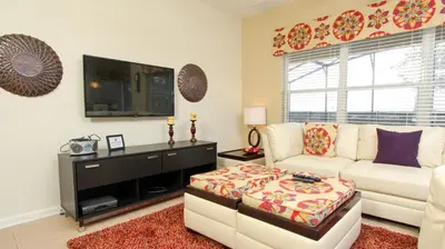 a living room with a white couch and a tv at 2582 Archfeld in Kissimmee