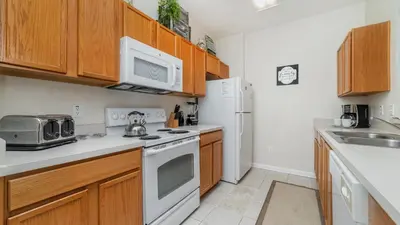 a kitchen with white appliances and wooden cabinets at 2774 Almaton #204 in Kissimmee