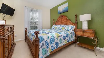 a bedroom with a bed and a dresser with a lamp at 2774 Almaton #204 in Kissimmee