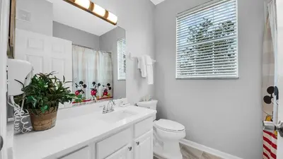 a white bathroom with a toilet and a sink at 2788 Almaton #301 in Kissimmee