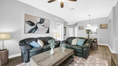 a living room with two leather couches and a coffee table at 2788 Almaton #301 in Kissimmee