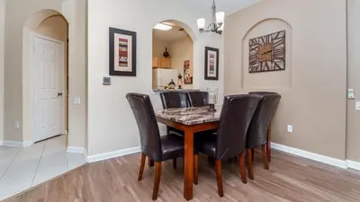 a dining room with a table and black chairs at 2809 Almaton #101 in Kissimmee