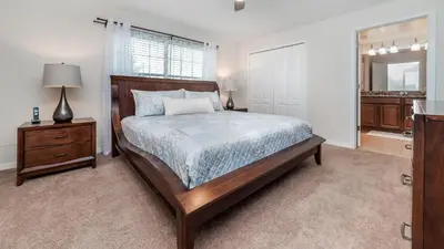 a bedroom with a bed and a dresser and a mirror at 3027 Beach Palm in Kissimmee
