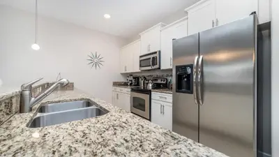 a kitchen with stainless steel appliances and granite counter tops at 3027 Beach Palm in Kissimmee