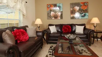 a living room with two leather couches and a table at 3043 Beach Palm in Kissimmee