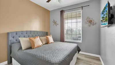 a bedroom with a bed with pillows and a window at 2301 Butterfly Palm #301 in Kissimmee
