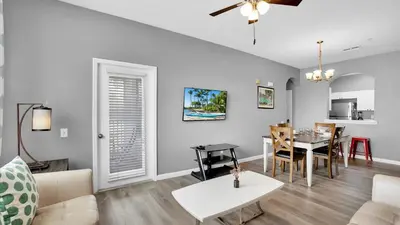 a living room with a table and a dining room at 2301 Butterfly Palm #301 in Kissimmee