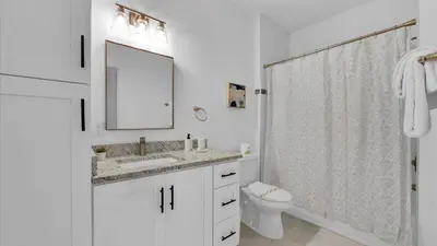 a bathroom with a sink and a toilet and a mirror at 2303 Butterfly Palm #102 in Kissimmee