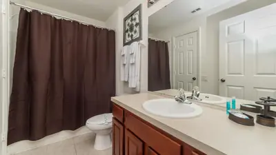 a bathroom with a sink and a toilet at 7795 Basnett in Kissimmee