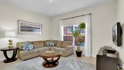 a living room with a couch and a table at 8959 California Palm in Kissimmee