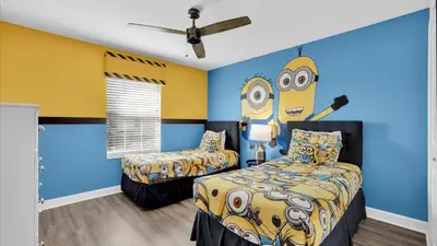 a bedroom with two beds and a yellow and blue wall at 3070 Gatsby in Kissimmee