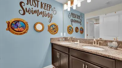 a bathroom with two sinks and a mirror at 3070 Gatsby in Kissimmee