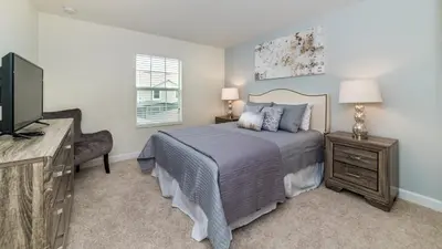 a bedroom with a bed and a flat screen tv at 3076 Juliet in Kissimmee